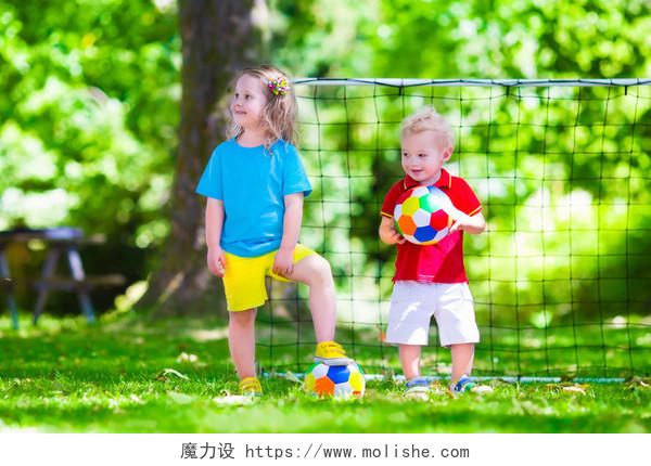 两个快乐的孩子们在学校的院子里玩欧洲足球幸福童年孩子幸福的人美好童年